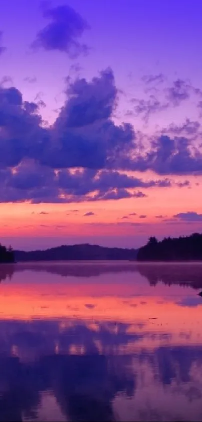 Serene sunset over lake with purple sky and orange reflections.