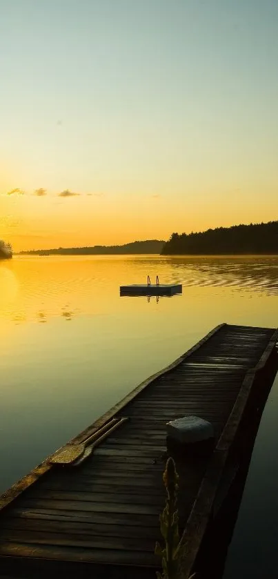 Serene golden sunset over a calm lake with a wooden dock.