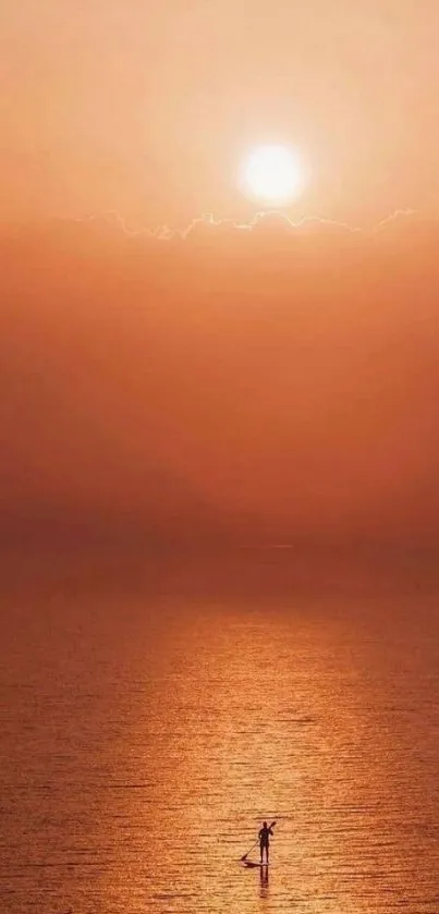 Tranquil sunset over ocean with orange hues dominating the scene.