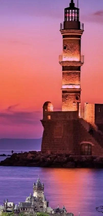 Lighthouse standing by the ocean at sunset with vibrant orange and pink colors.