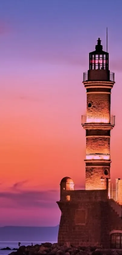 Lighthouse against a vivid sunset sky with purple and orange hues.