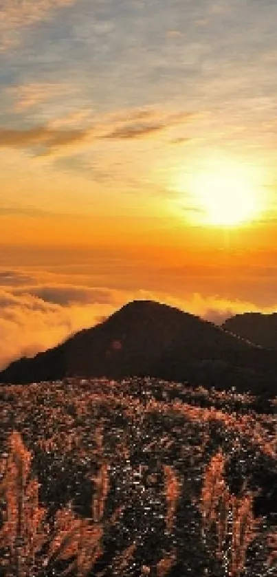 Golden sunset over mountain peaks with clouds and serene sky.