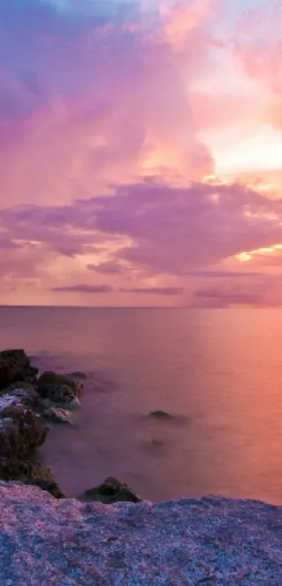 Serene ocean sunset with purple and orange hues.