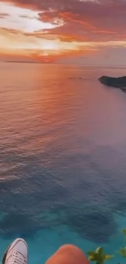 Peaceful ocean sunset view with vibrant sky over calm waters.