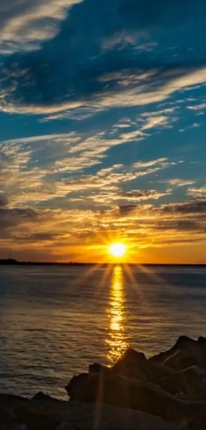 Sunset over the ocean with golden hues and a serene sky, reflecting tranquility.