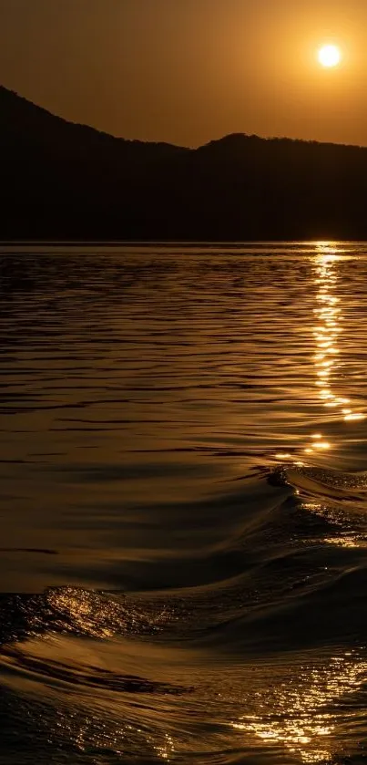 Golden sunset over ocean waves with a tranquil horizon.