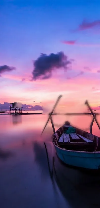 Sunset over calm waters with a boat and vibrant pink and blue skies.