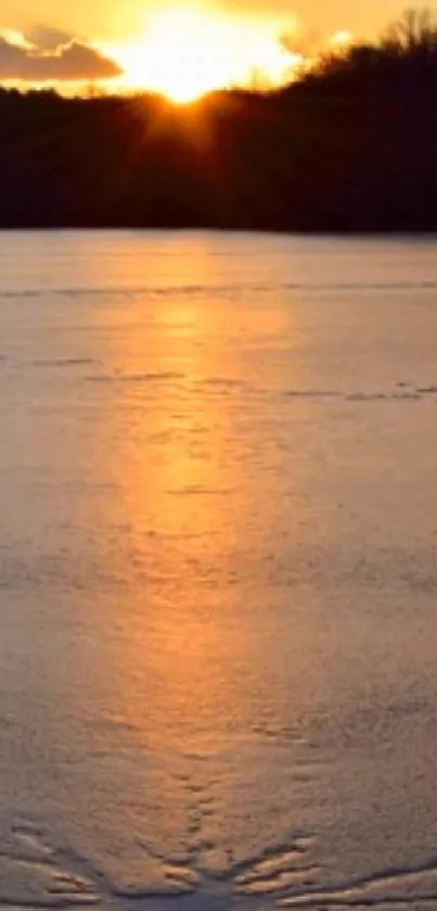 Serene sunset over a frozen lake reflecting golden hues.