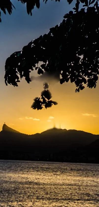 Sunset view with mountain silhouette over calm water, under a twilight sky.