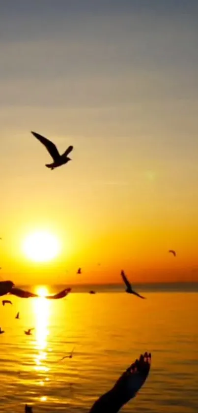 A stunning sunset with seagulls flying over a golden ocean.