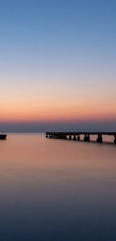 Sunset over ocean with pier silhouette creating a tranquil scene.