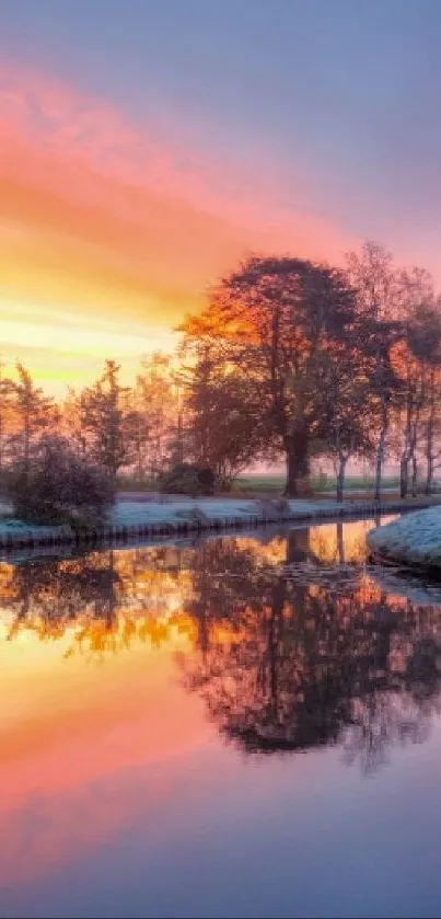 Serene sunset over river reflecting vivid orange and purple sky.