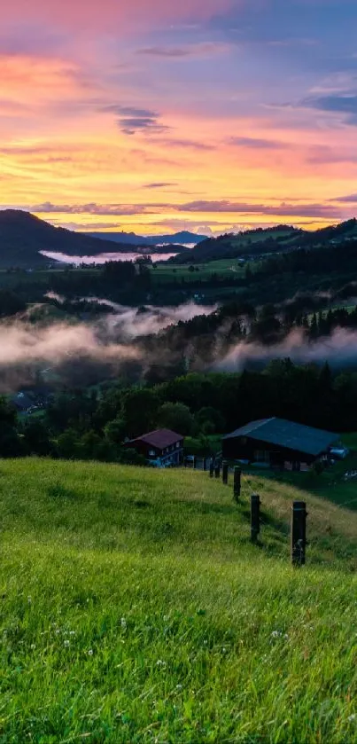 Beautiful sunset over green hills and misty landscape, perfect for mobile wallpaper.