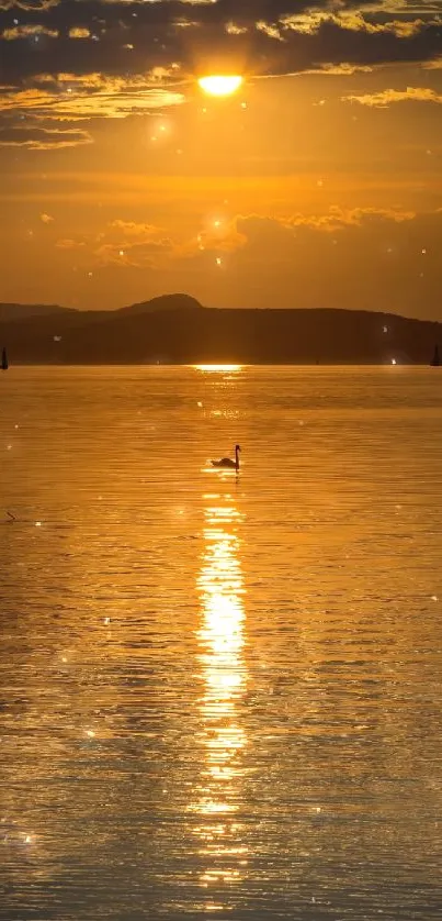 Sunset over lake with golden reflections and bird silhouette.