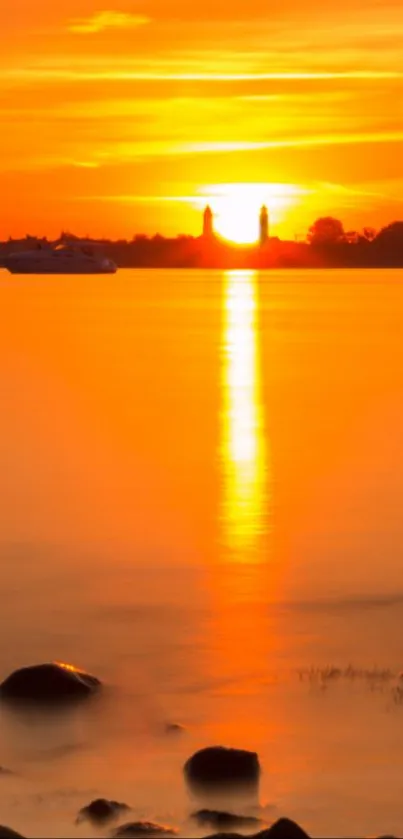 Serene sunset over a calm body of water reflecting warm orange hues.