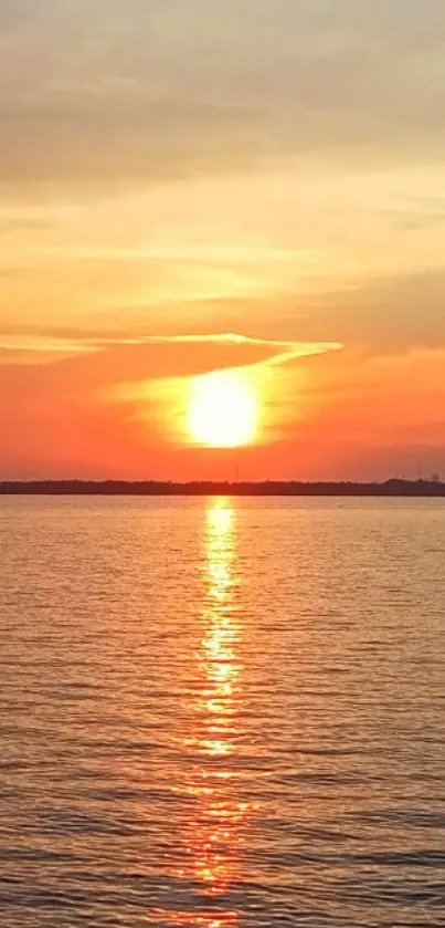 Serene sunset over water with orange and warm tones.