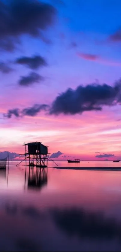 Serene sunset over calm water with pink and blue hues.