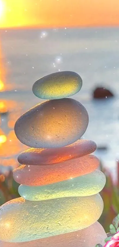 Balanced pebbles at sunset with ocean view in background.