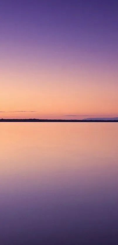 Tranquil purple sunset over calm waters, perfect for phone wallpaper.