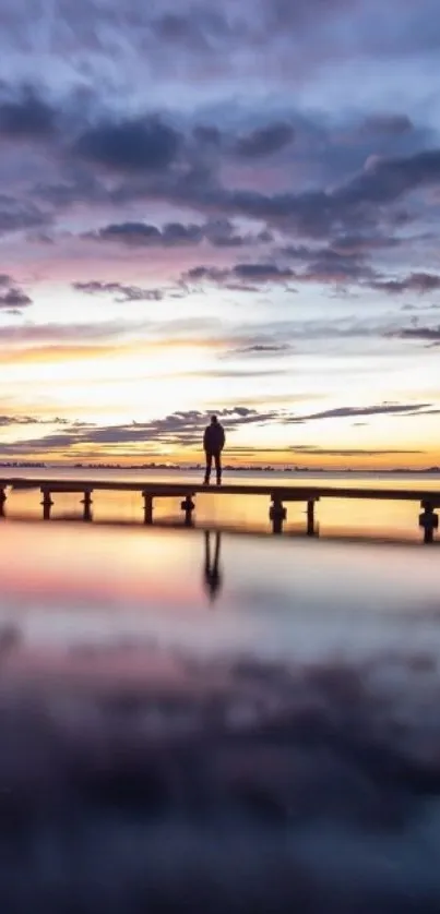 Serene sunset reflecting over calm waters at a quiet pier.