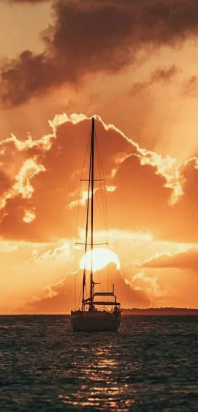 Silhouette of a boat sailing against a breathtaking orange sunset sky.