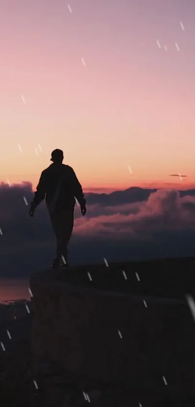 Silhouette walking against a colorful sunset sky with clouds.