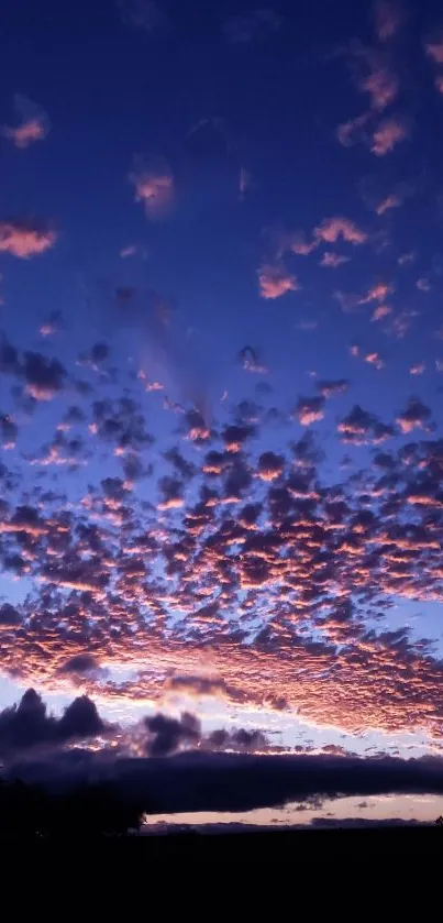 A scenic view of a sunset sky with purple and pink clouds.