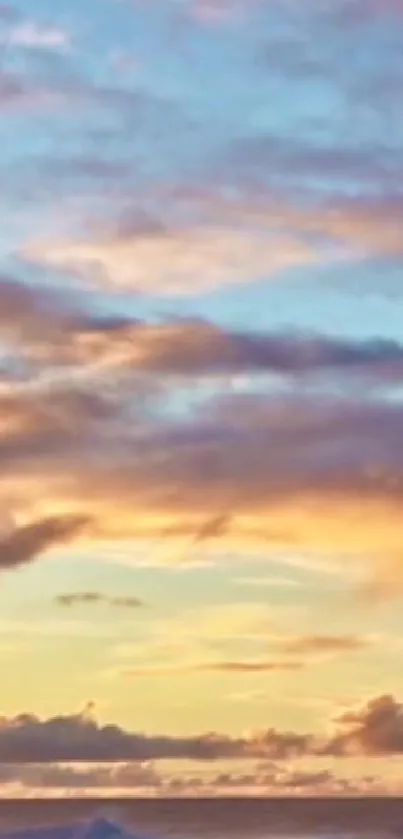 Serene sunset sky with vibrant orange, blue, and purple clouds over the ocean.