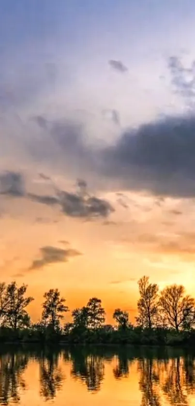 Sunset reflecting on calm water with trees silhouetted against sky.