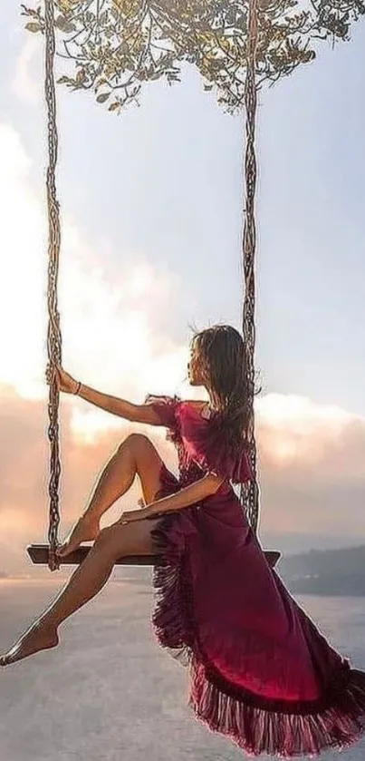 Woman in pink dress swinging over a scenic ocean view at sunset.