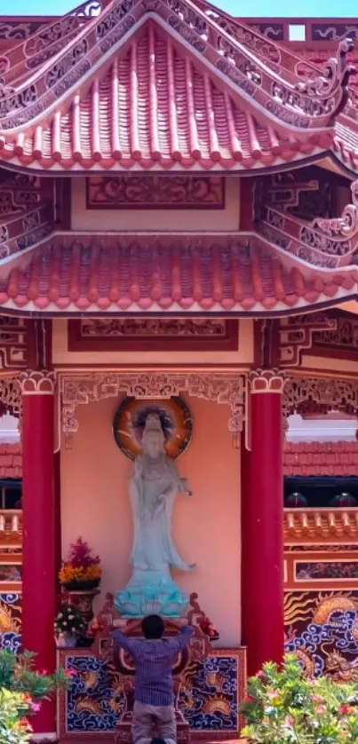 Serene temple scene with red roofs and a central statue.