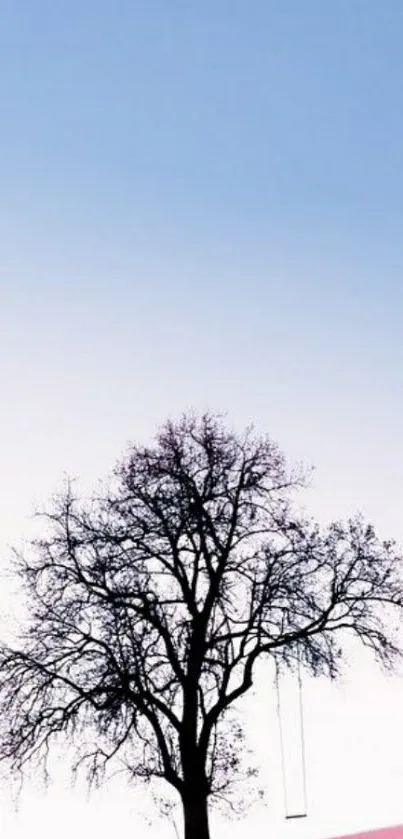 Solitary tree on a pink hill with a blue sky gradient background.