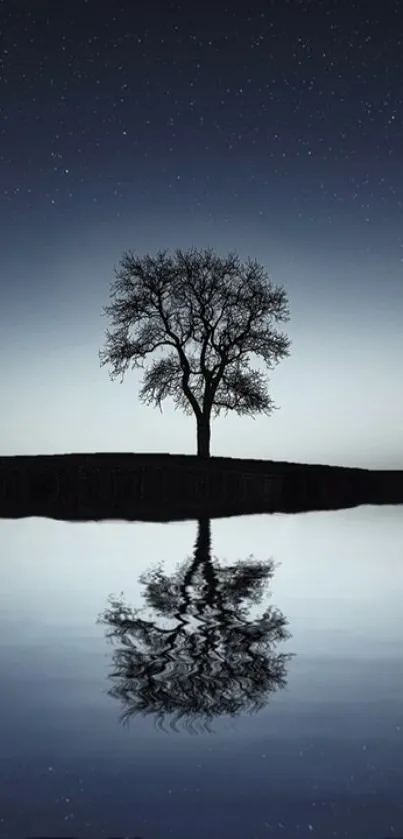 Solitary tree reflecting in calm water under a starry night sky.