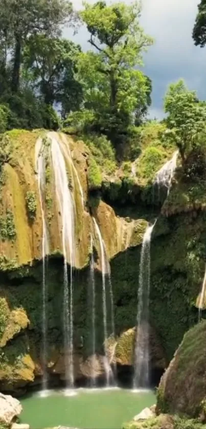 Serene tropical waterfall in lush greenery.