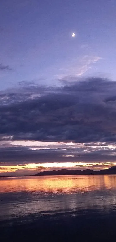 Serene twilight over water with calm reflections and darkening sky.