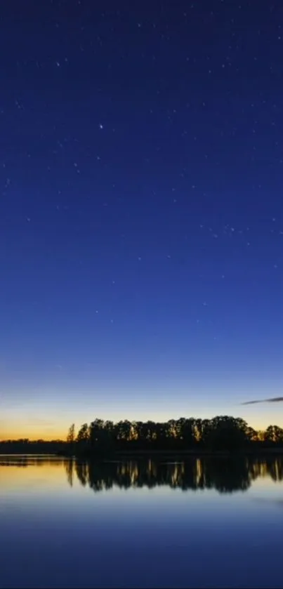 Twilight sky with stars reflecting on a calm lake.