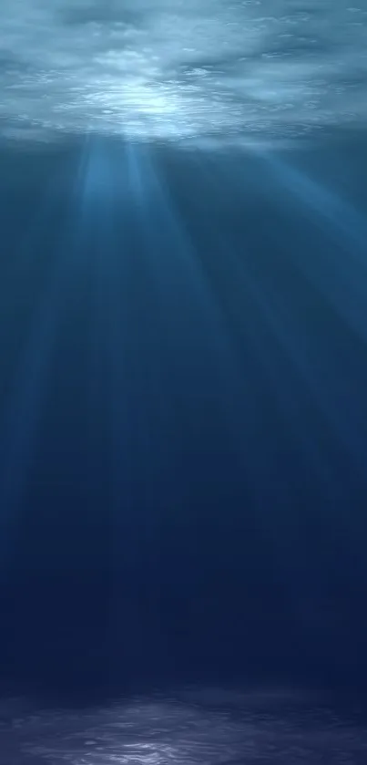 Serene deep blue underwater scene with light rays.