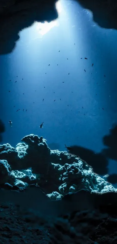 Serene underwater cave view with sunlit blue waters and vibrant coral formations.