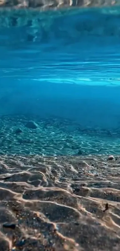 Serene underwater ocean scene with sandy floor and blue waves.