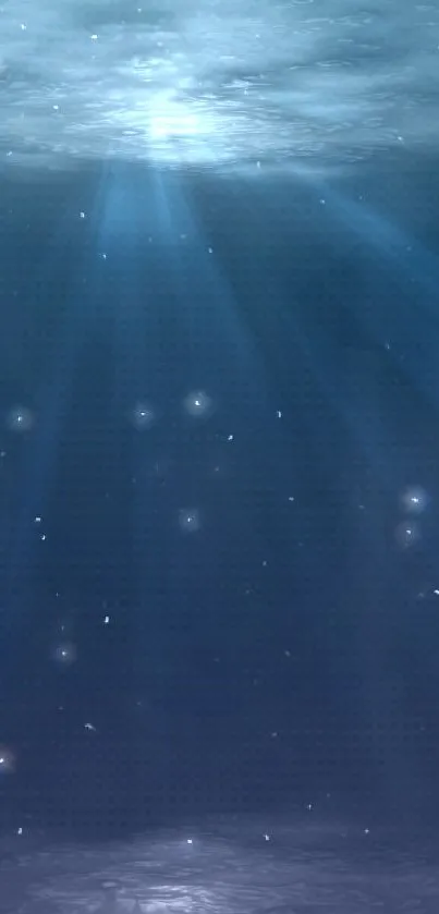 Serene underwater ocean wallpaper with blue hues and gentle light rays.