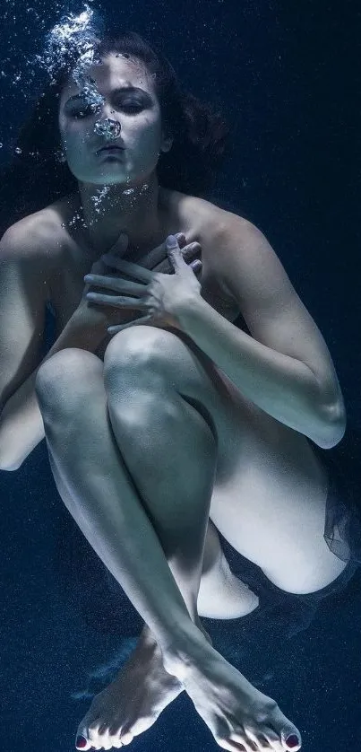 Woman gracefully underwater with reflective serenity and elegance.