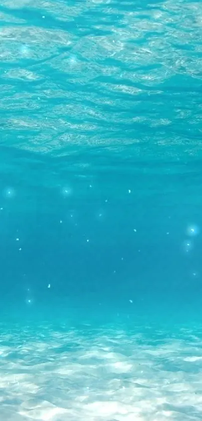 Underwater view with turquoise water and gentle waves.