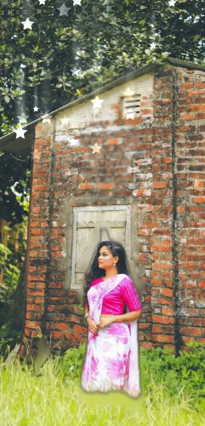 Woman in colorful sari by brick house under starry leaves.