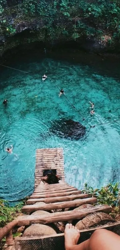 Aerial view of people swimming in a tropical lagoon with a wooden ladder.