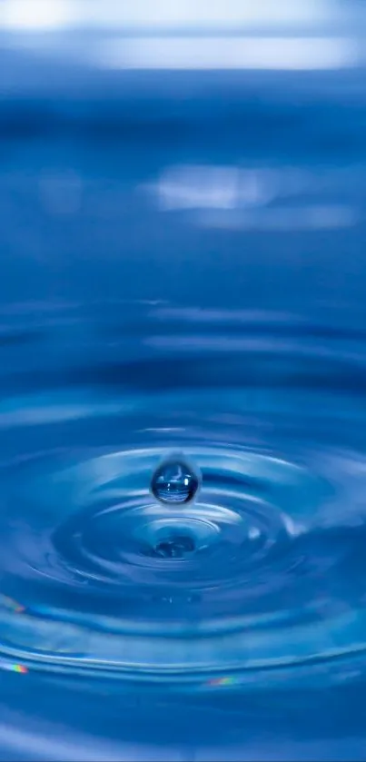 Serene blue water droplet creates ripples.