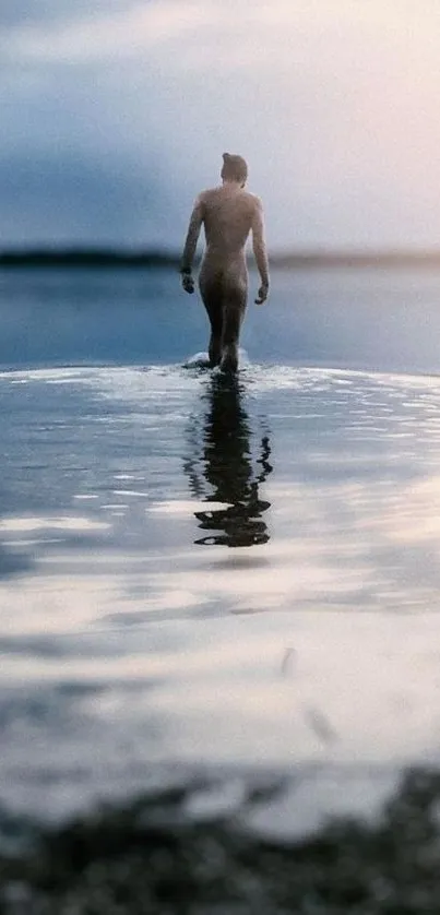 A lone figure stands in calm water, reflecting the serene landscape.