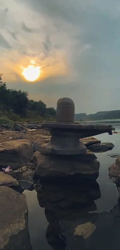 Tranquil sunset with rocks and water reflection in nature.