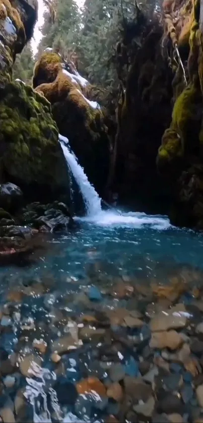 Serene waterfall in a lush canyon landscape with teal blue waters.