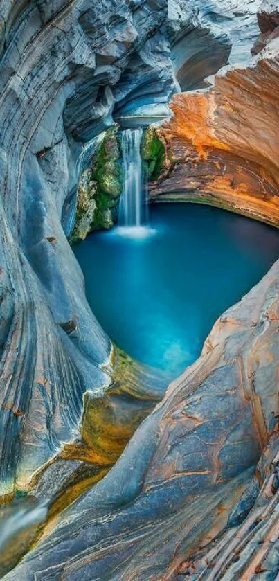 Serene canyon with vibrant blue waterfall and surrounding rock formations.