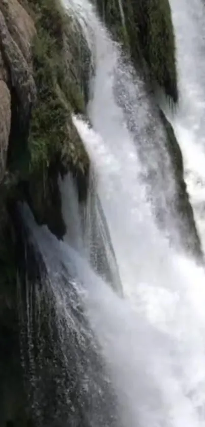 Serene waterfall cascading down rocks in a tranquil nature scene.